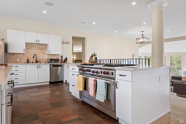 kitchen featuring stainless steel appliances, tasteful backsplash, light countertops, recessed lighting, and white cabinets