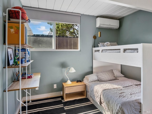 bedroom featuring wood ceiling, baseboards, and a wall unit AC