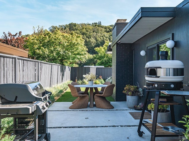 view of patio / terrace featuring a fenced backyard, outdoor dining area, and a grill