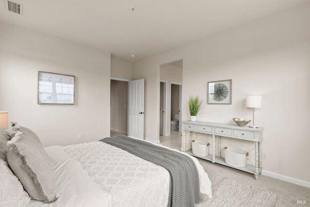 carpeted bedroom featuring baseboards and visible vents
