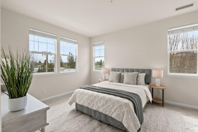 carpeted bedroom featuring baseboards and visible vents