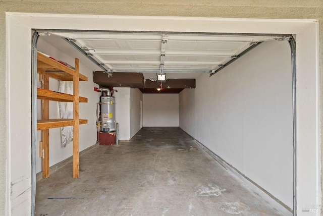 garage featuring water heater and a garage door opener