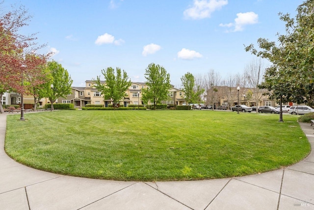 view of property's community featuring a yard and a residential view