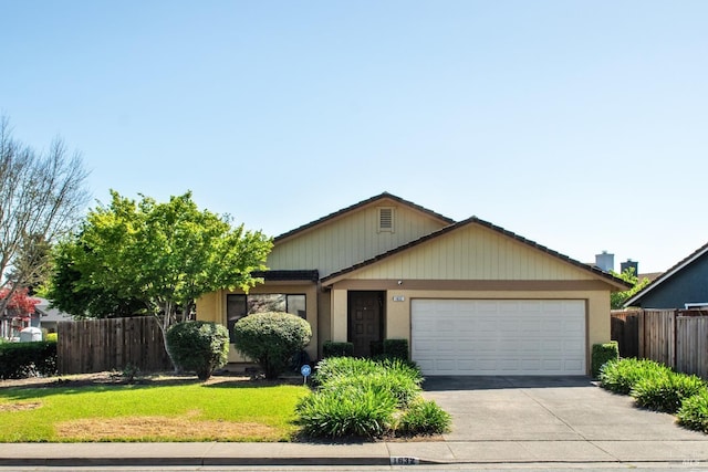 single story home with fence, a front yard, a garage, and concrete driveway