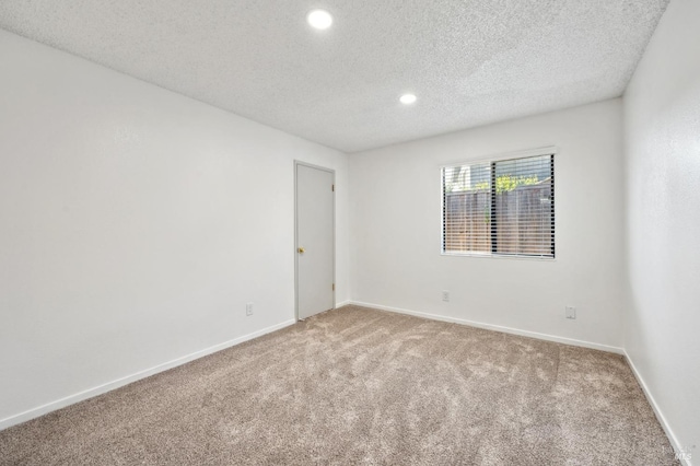 unfurnished room with recessed lighting, baseboards, carpet floors, and a textured ceiling