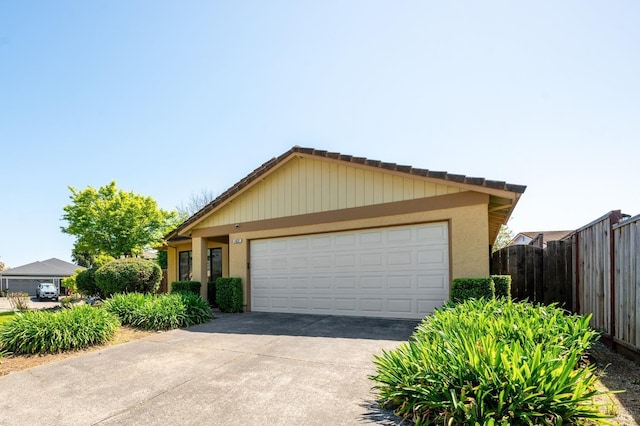 ranch-style home featuring stucco siding, driveway, a garage, and fence