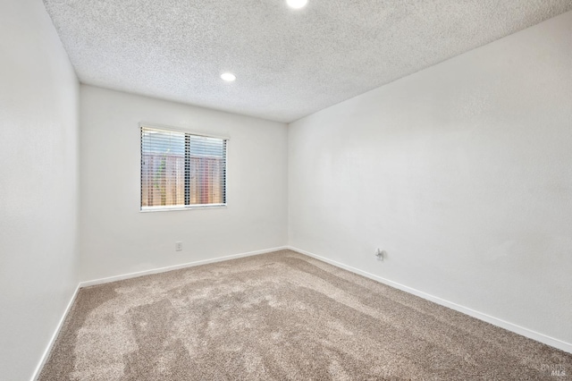 unfurnished room with recessed lighting, baseboards, carpet floors, and a textured ceiling