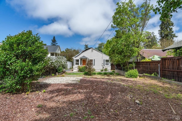 rear view of property featuring fence