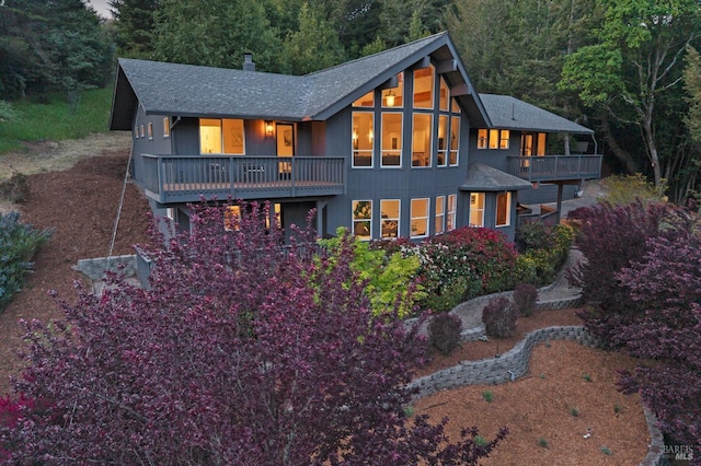 750 Wagnon Rd, Sebastopol, CA 95472 - back of property with a balcony, roof with shingles, a forest view, and a chimney