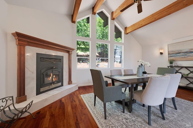 dining area with a wealth of natural light, lofted ceiling with beams, ceiling fan, and wood finished floors