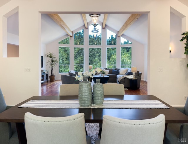 dining area with beam ceiling, wood finished floors, baseboards, and high vaulted ceiling