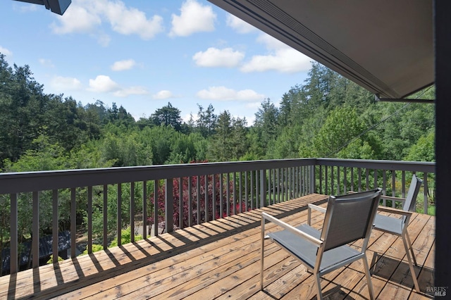 wooden terrace with a forest view