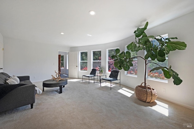 carpeted living area with recessed lighting and baseboards