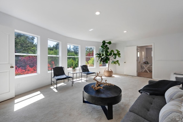 living room featuring recessed lighting, light carpet, and plenty of natural light