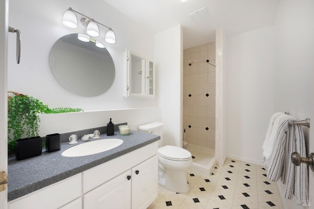 full bathroom featuring toilet, tile patterned floors, a shower stall, and vanity
