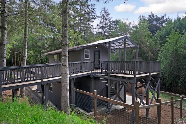 rear view of property featuring a wooden deck