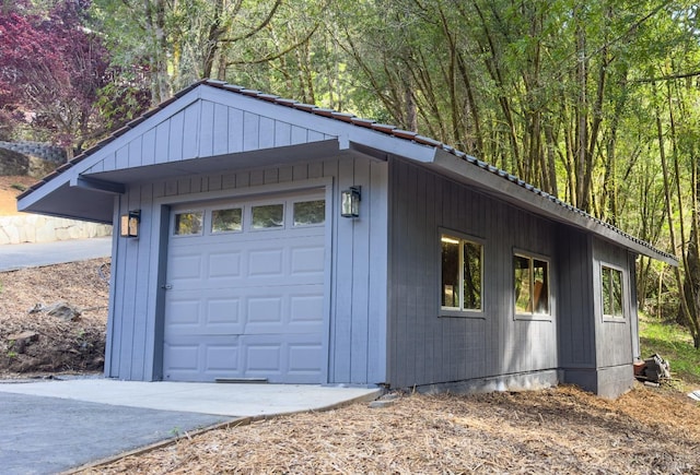 garage featuring concrete driveway
