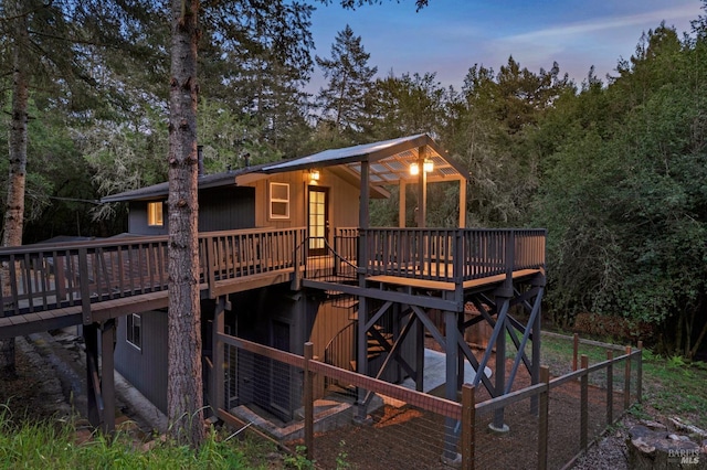 rear view of house featuring a wooden deck