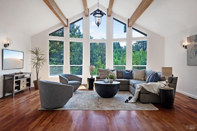 living area with visible vents, beam ceiling, wood finished floors, baseboards, and high vaulted ceiling