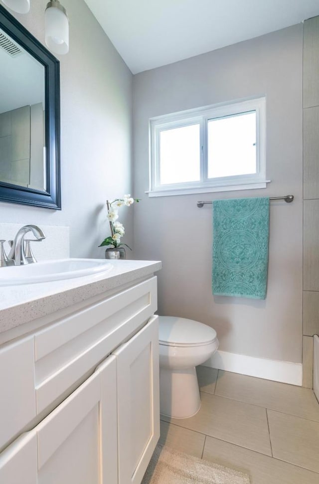 full bathroom featuring toilet, visible vents, baseboards, tile patterned flooring, and vanity