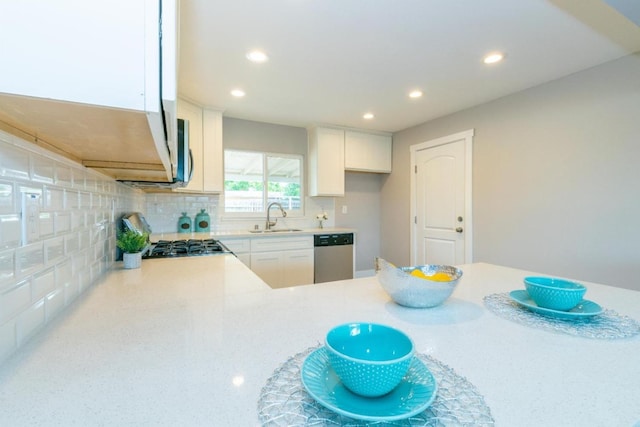 kitchen featuring light countertops, appliances with stainless steel finishes, recessed lighting, and a sink