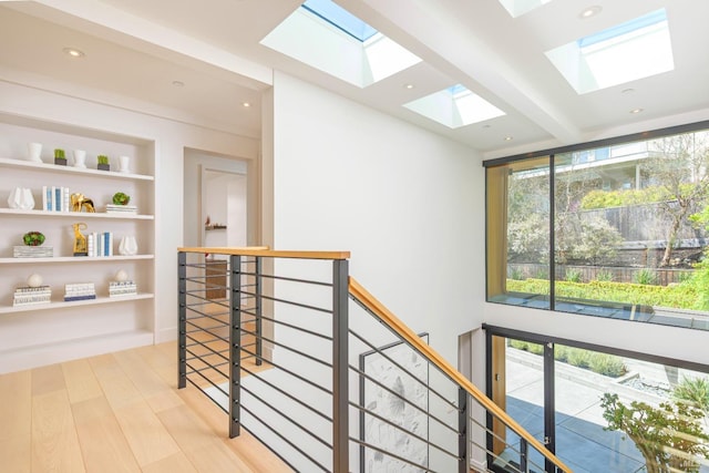 86 Sugarloaf Dr, Tiburon, CA 94920 - corridor with an upstairs landing, light wood-type flooring, recessed lighting, a skylight, and built in shelves