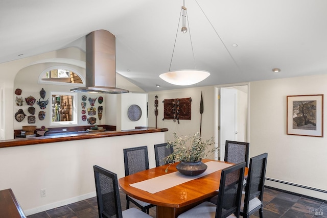 dining space with baseboards, vaulted ceiling, stone finish flooring, and baseboard heating