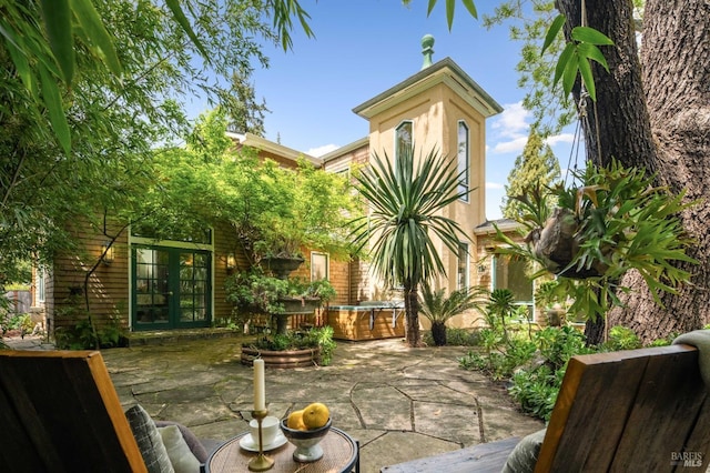 back of property with french doors and a patio