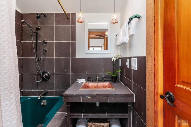 full bathroom with a sink, shower / bathtub combination with curtain, and tile walls