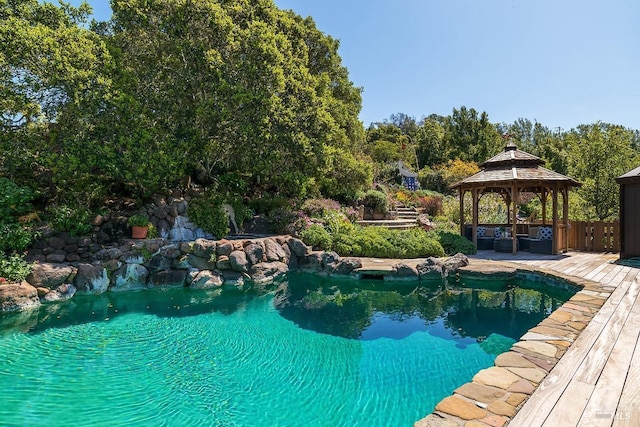 view of swimming pool with a wooden deck and a gazebo