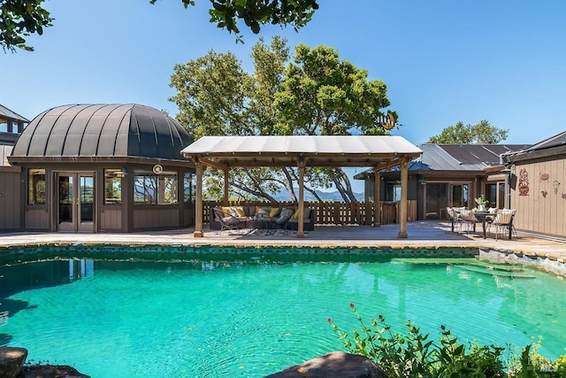 outdoor pool featuring a patio area, french doors, and a gazebo