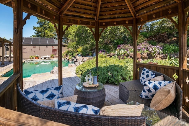 wooden terrace featuring a gazebo and a fenced in pool