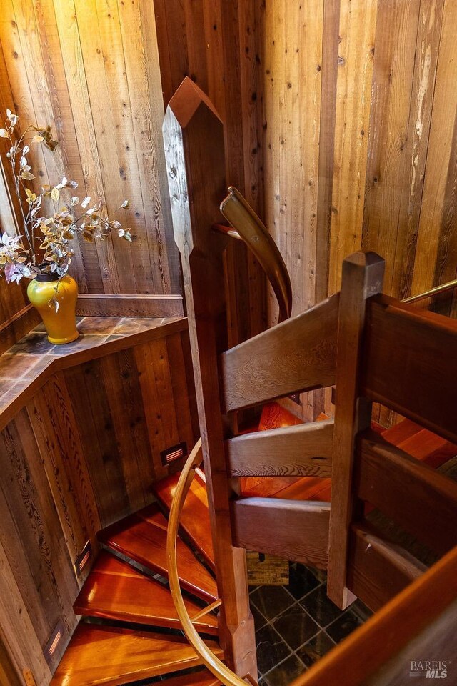 stairway with wood walls