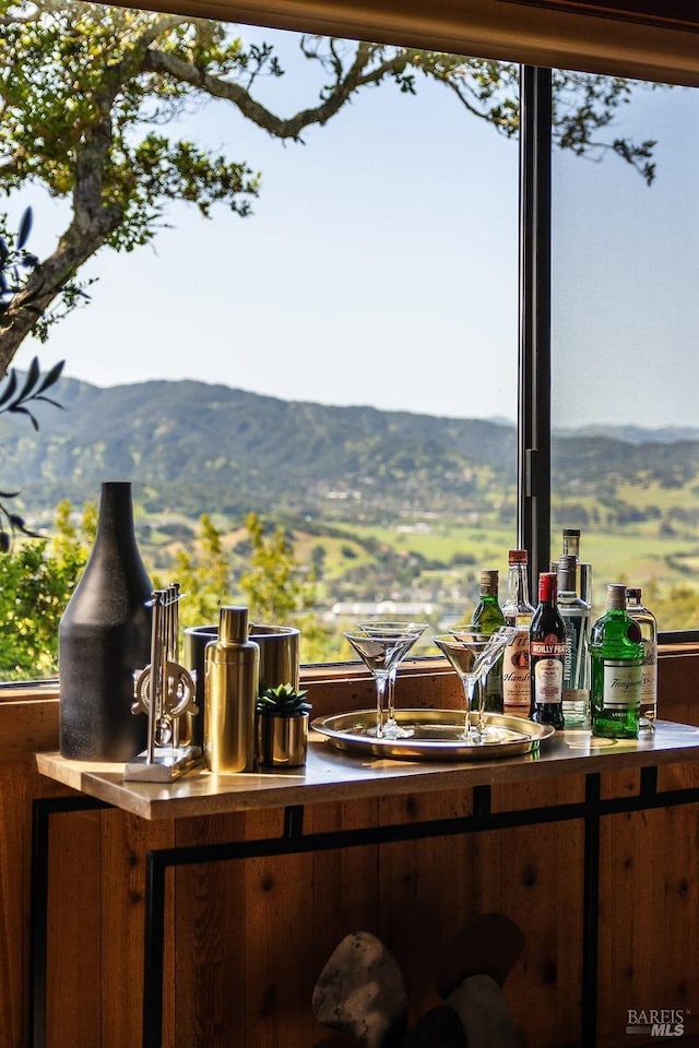 bar with a healthy amount of sunlight, a bar, and a mountain view