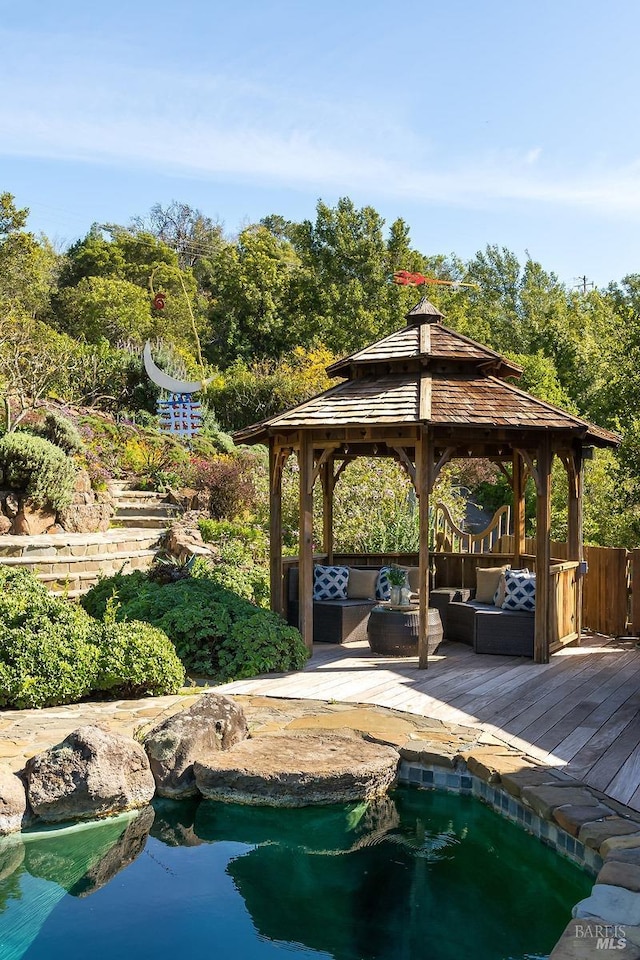 view of home's community featuring a gazebo, an outdoor hangout area, and a deck