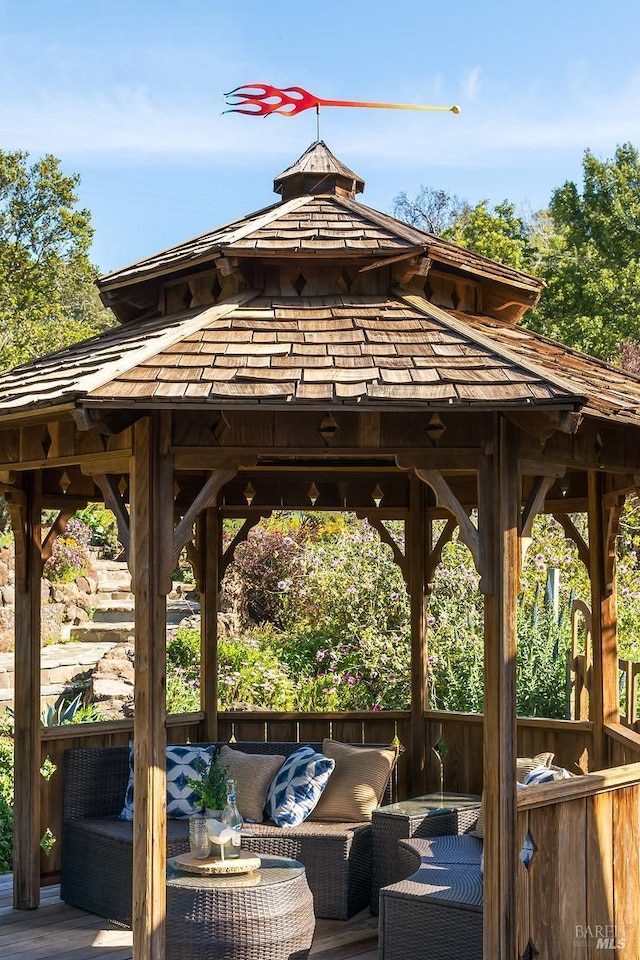 wooden deck featuring a gazebo and an outdoor hangout area