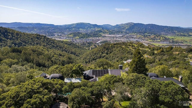 drone / aerial view with a mountain view and a wooded view