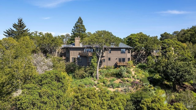 exterior space featuring a wooded view