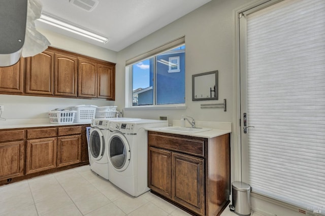 439 Mckenna Ct, Benicia, CA 94510 - clothes washing area with visible vents, light tile patterned floors, washing machine and dryer, a sink, and cabinet space
