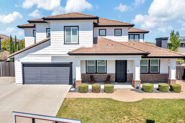 439 Mckenna Ct, Benicia, CA 94510 - view of front of home with concrete driveway, covered porch, a garage, brick siding, and fence