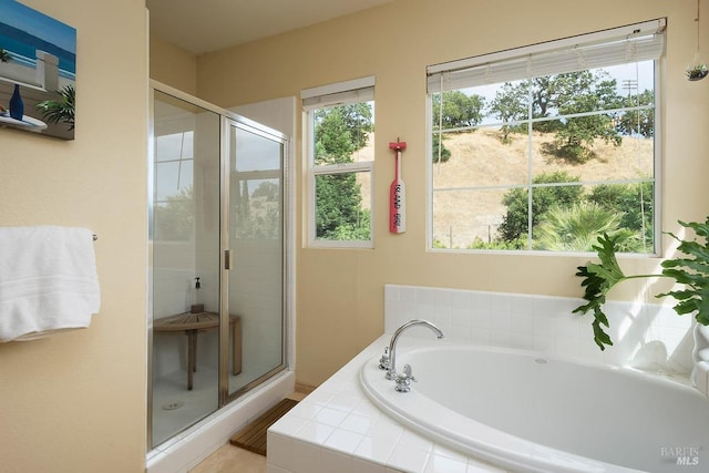 bathroom featuring a bath and a stall shower