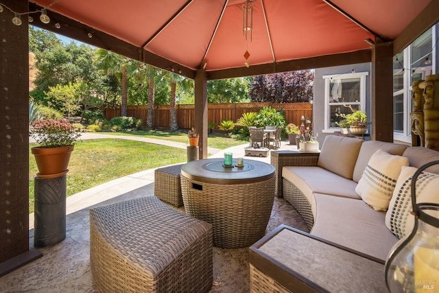 view of patio / terrace featuring outdoor dining area, outdoor lounge area, fence, and a gazebo