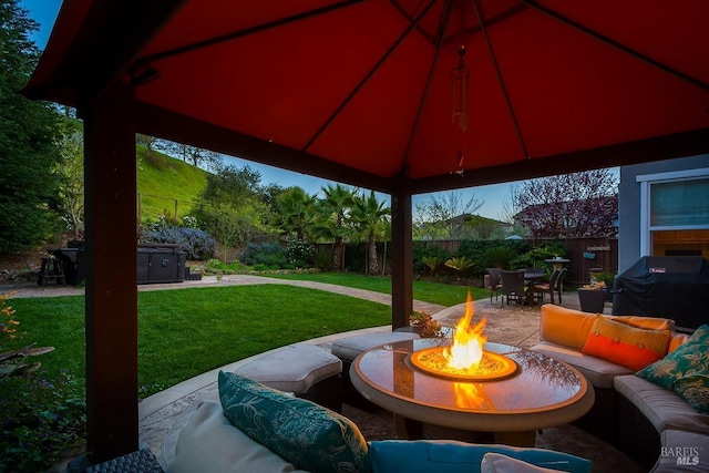view of patio featuring an outdoor living space with a fire pit, a fenced backyard, area for grilling, and outdoor dining area