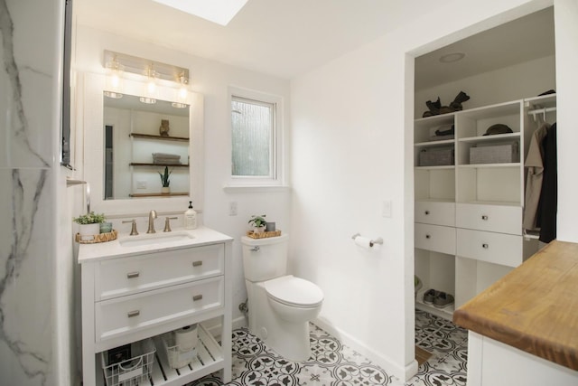 7600 Scenic Ct, Fair Oaks, CA 95628 - bathroom with toilet, vanity, and baseboards