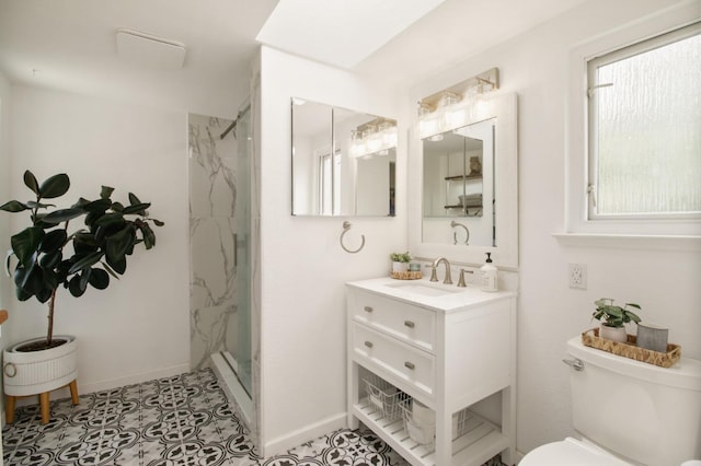 full bathroom featuring baseboards, a marble finish shower, toilet, and vanity
