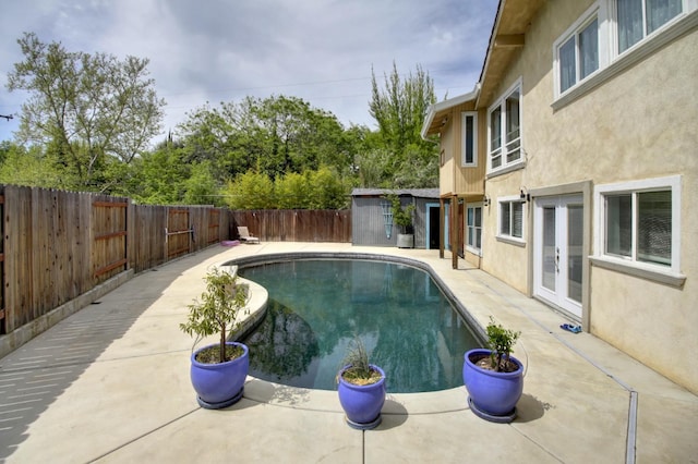 view of pool featuring a fenced in pool, a patio, french doors, and a fenced backyard