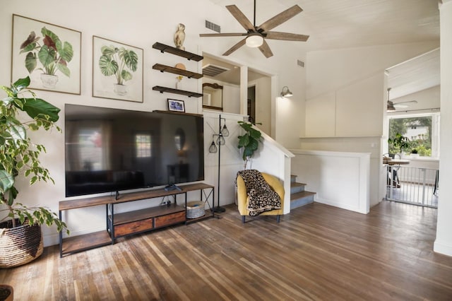 living room featuring a ceiling fan, stairs, wood finished floors, and lofted ceiling