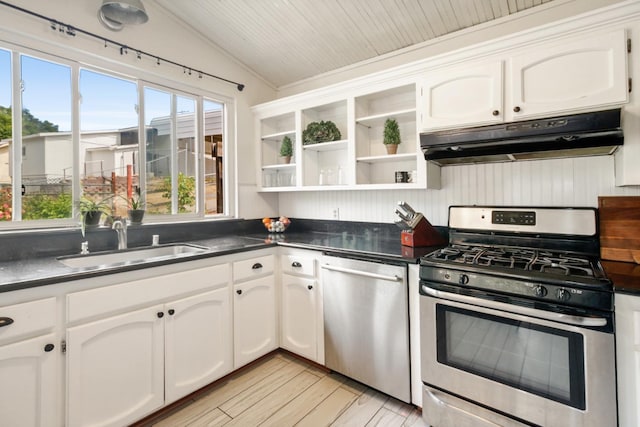 kitchen with stainless steel appliances, open shelves, under cabinet range hood, vaulted ceiling, and a sink
