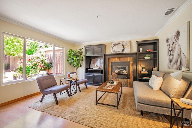 119 Philip Dr, Healdsburg, CA 95448 - living area with crown molding, light wood-style floors, a tile fireplace, and baseboards
