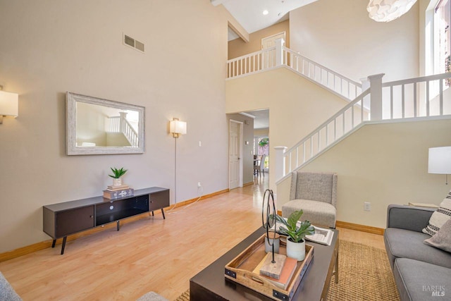 119 Philip Dr, Healdsburg, CA 95448 - living room featuring high vaulted ceiling, wood finished floors, baseboards, and stairs